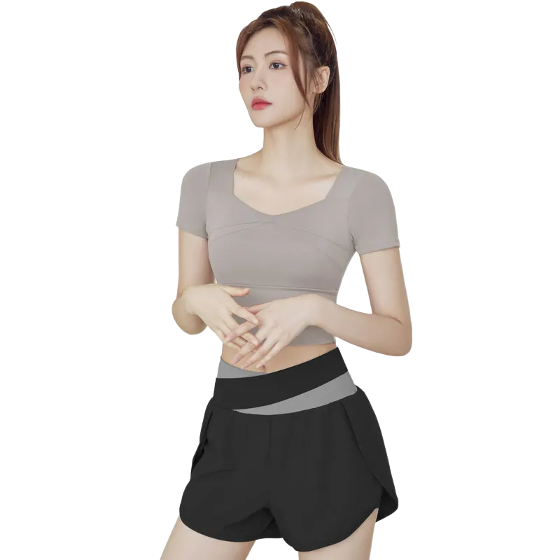 a black athletic two-piece set consisting of a fitted V-neck short-sleeve top and matching shorts with a distinct grey elastic waistband.