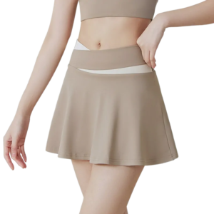 Alternative Text A woman's lower body wearing a beige A-line mini skirt with a white contrast waistband. Her hands rest gently behind her back. The soft, slightly flared skirt is shown against a plain white background. Title for Google Search Beige A-Line Mini Skirt for Women - White Contrast Waistband Casual Tennis Skirt, Flared Fit