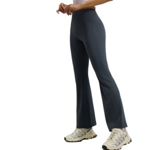 dark grey fitted flare-leg pants and light grey lace-up sneakers. The pants are made of soft, stretchy athletic fabric that flares slightly from the knee down.