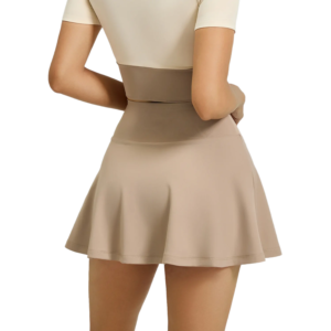 a light beige A-line athletic skirt with a high waist. The skirt features a wide, asymmetrical diagonal stripe in white along the waistband, creating a modern contrast. The smooth, stretchy fabric allows the skirt to flare slightly.