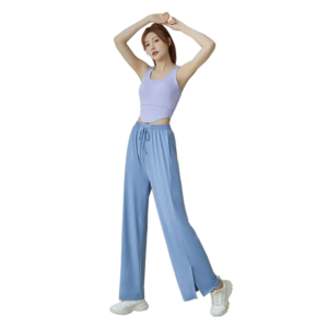 A woman wearing light blue wide-leg pants with an elastic drawstring waist and side pockets.
