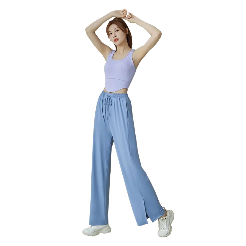 A woman wearing light blue wide-leg pants with an elastic drawstring waist and side pockets.