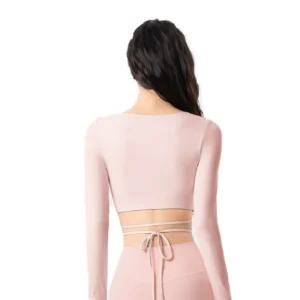 wholesale long sleeve top in light pink with asymmetric neck and white crisscross strap detail