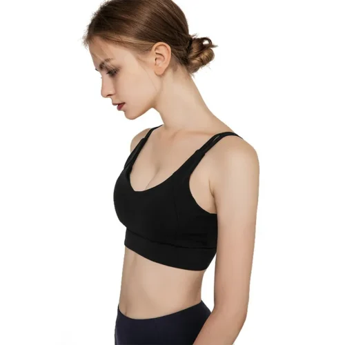a black sleeveless sports bra with a deep U-neckline and crisscross straps. The wide, double-layered straps and seamless design provide support and coverage.