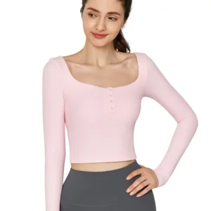 wholesale long sleeve crop top in pink with square neck and three-button front, model front view on solid background