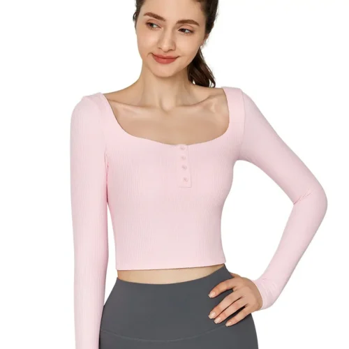 wholesale long sleeve crop top in pink with square neck and three-button front, model front view on solid background