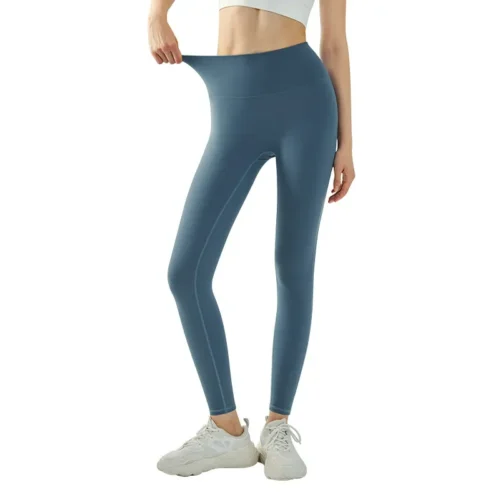 wholesale navy blue fitness leggings with high waistband, close-up detail of hand pulling waistband to show elasticity and fit