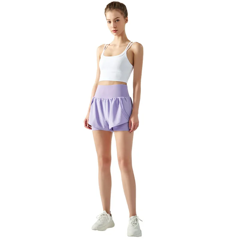 a light purple high-waisted athletic skort. The garment features a wide, fitted waistband and a flared skirt overlay with side pleats for a dynamic look.