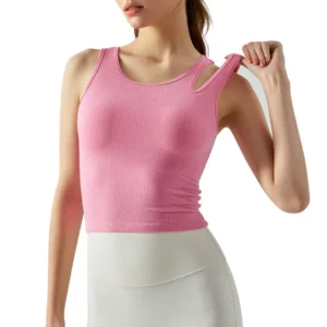 fitted pink sleeveless sports top. The top has a subtle scoop neckline, and a distinctive circular cut-out detail on the right strap.