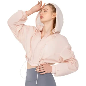 a light pink, cropped hooded jacket with a front zipper and drawstrings