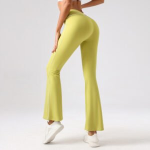 yellow flare-leg leggings with white side stripe detailing, paired with white sneakers.