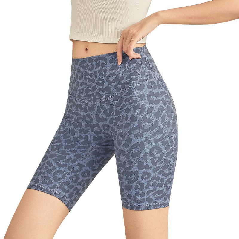 blue leopard-print high-waisted cycling shorts. The form-fitting shorts end above the knee, made of a sleek, stretchy fabric.