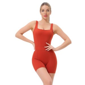 a striking red sleeveless bodysuit. The garment features a square neckline, wide adjustable straps, and a form-fitting silhouette that transitions into high-cut shorts.