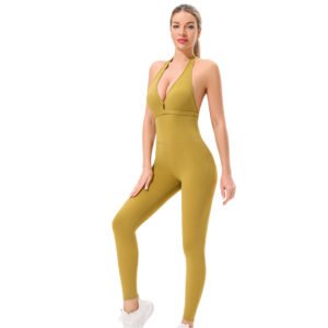 a one-piece form-fitting activewear set in a striking mustard yellow. The design features a halter neck with a deep V-neckline and a high-waisted leggings bottom. The outfit accentuates the figure's curves.