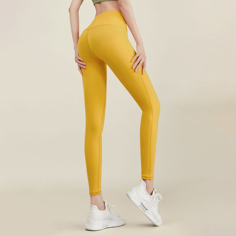 lower body wearing vibrant yellow high-waisted fitted leggings
