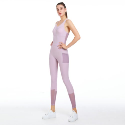 The outfit features a sleeveless design with mesh paneling on the sides and a functional pocket on the right thigh.