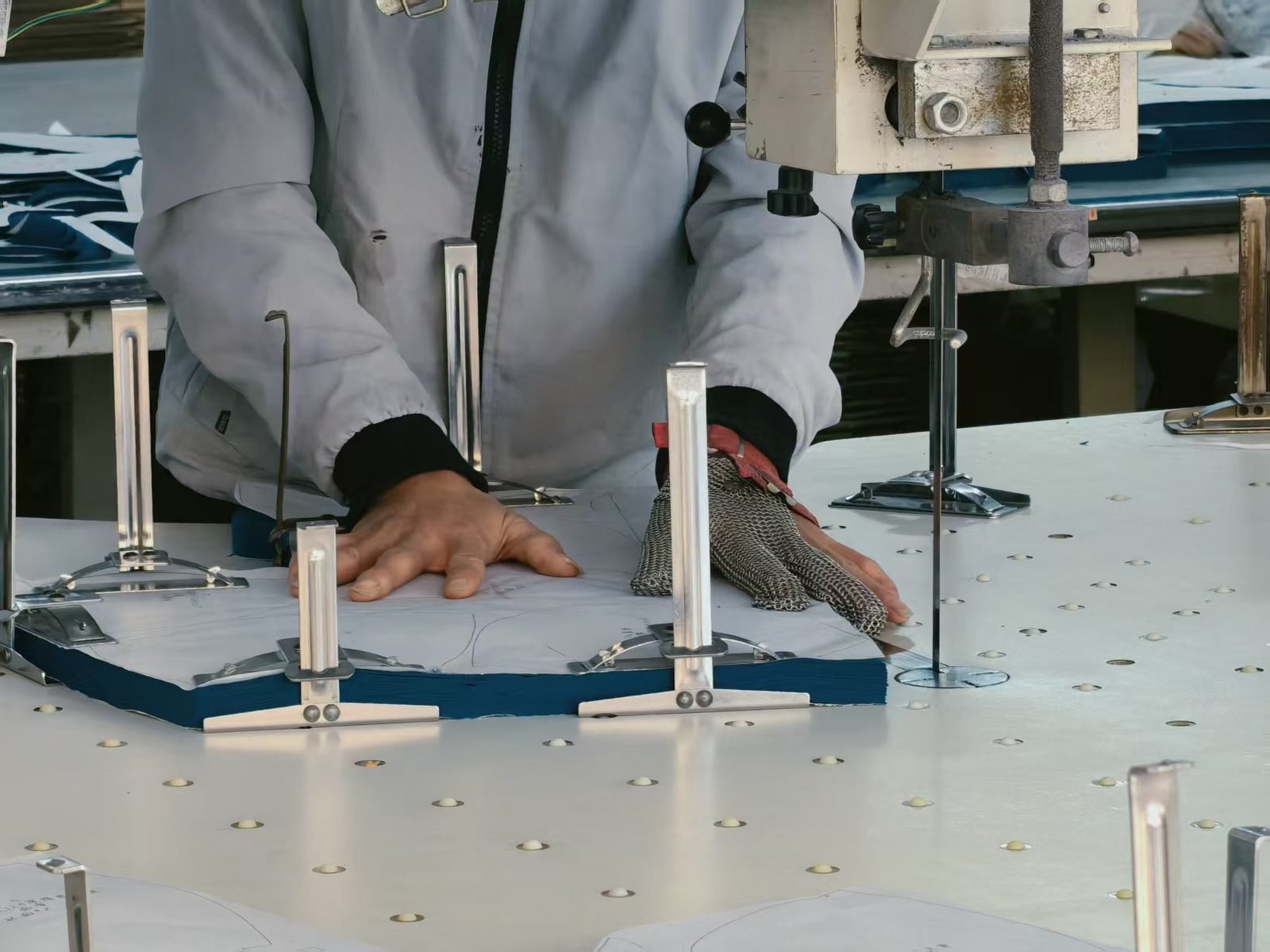 Cutting stacked swimwear fabric layers with a band knife cutting machine