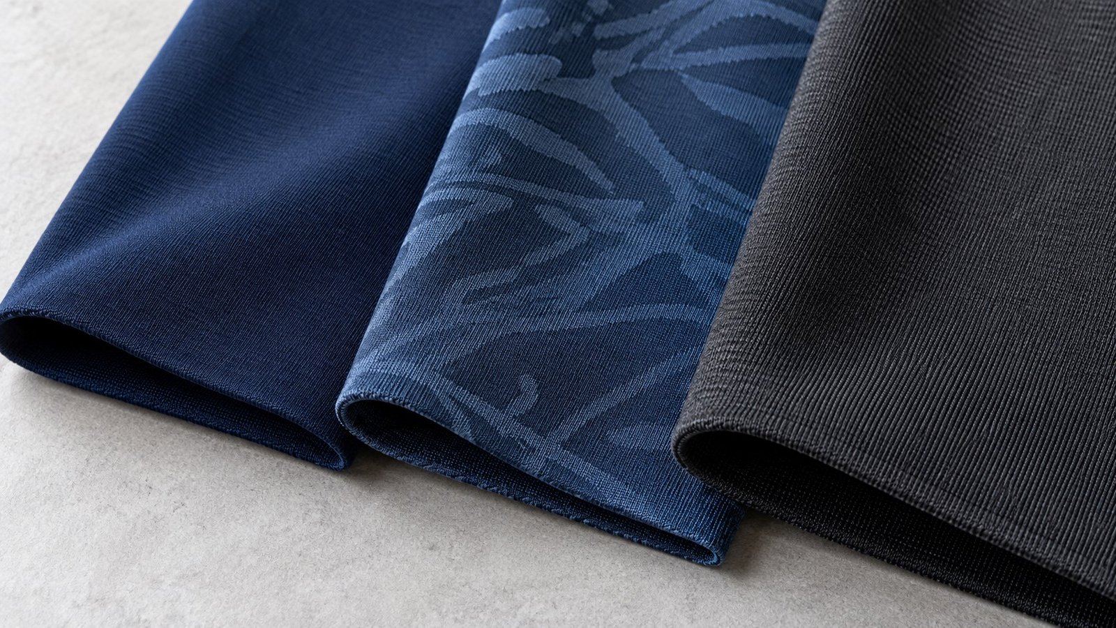 Close-up of quick dry rash guard fabric swatches in nylon-spandex, polyester-spandex and chlorine-resistant PBT